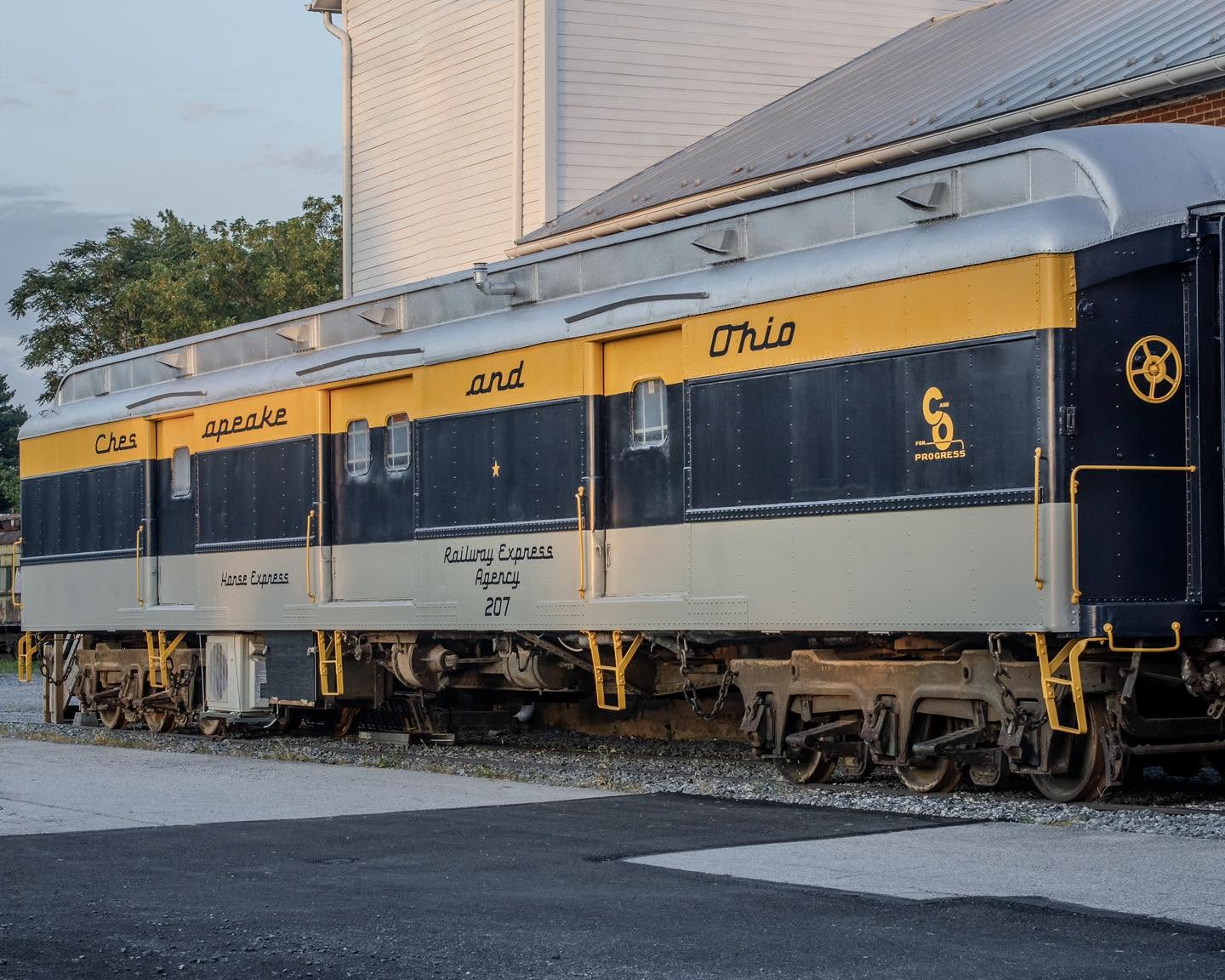 The restored blue, yellow, and gray Chesapeake and Ohio horse car that houses the club layout
